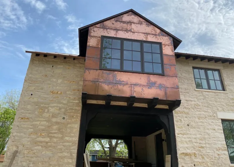 Copper metal panel facade on a stone building for Skylight Installation in Ponchatoula